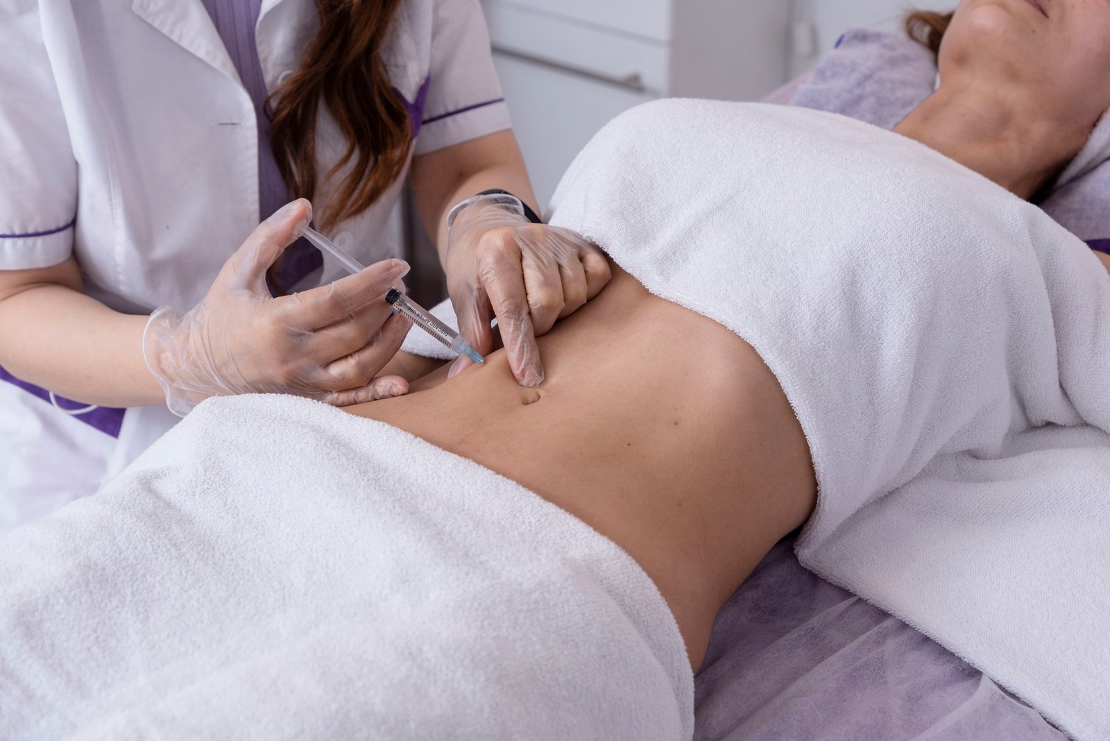 close-up of body mesotherapy injections on the female belly, cellulite treatment.